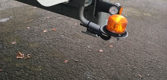 Two LED beacons installed on swinging stems at the rear of the equipment