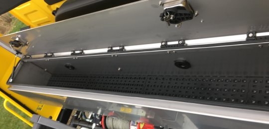 A stainless steel toolbox with top opening over the entire width fitted on the front of equipment
