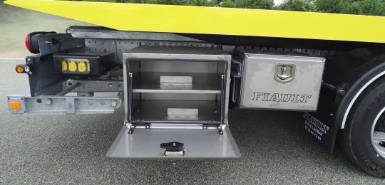 A closed stainless steel storage box with a fixed shelf for two wheel dollies type "GO-JACK 5000" (without dollies)